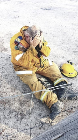 After many days fighting fires, Aaron Cox, photographed  immediately after saving his own home Ballandean, NSW. Image by his wife, Bindi Cox