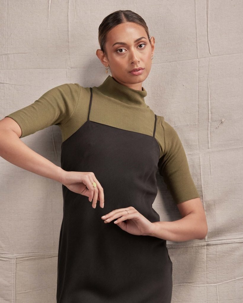 Short sleeve olive turtleneck worn under a black slip dress