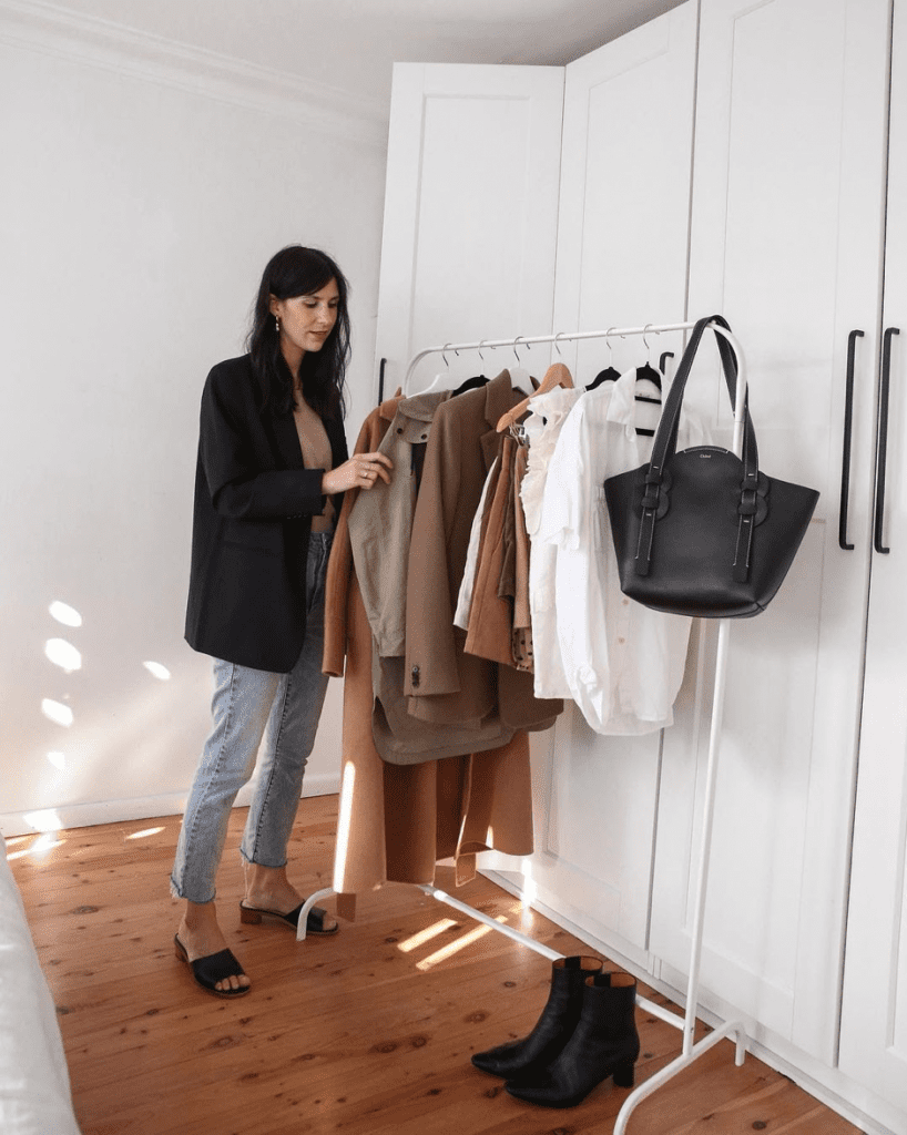 Conscious Consumer looking at her clothes on a rack