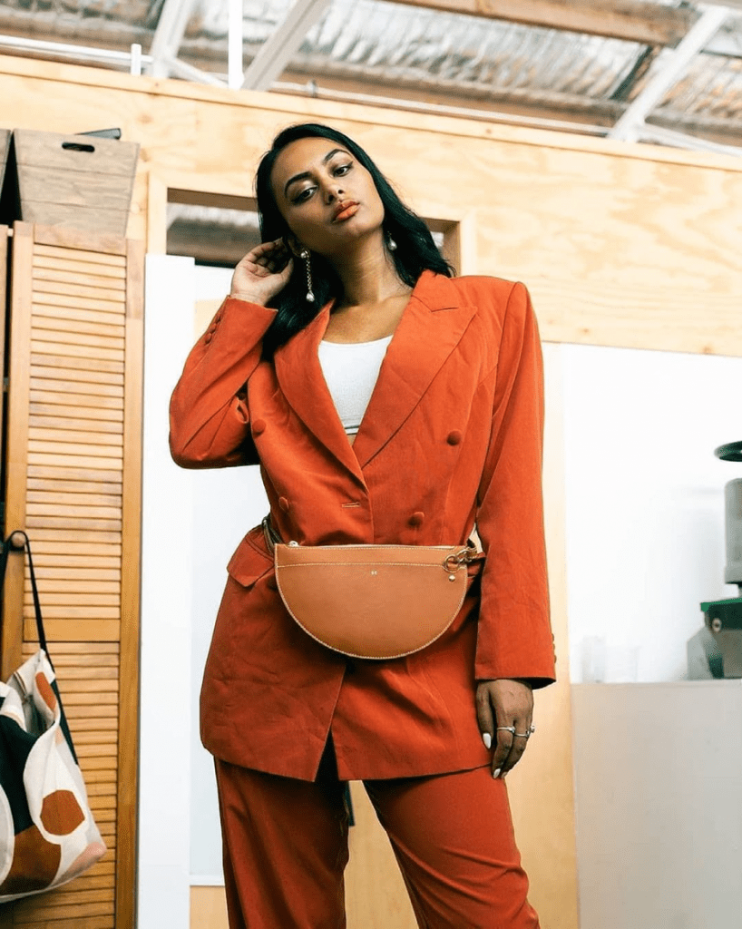 Stylish woman in Tanerine suit and matching bum bag